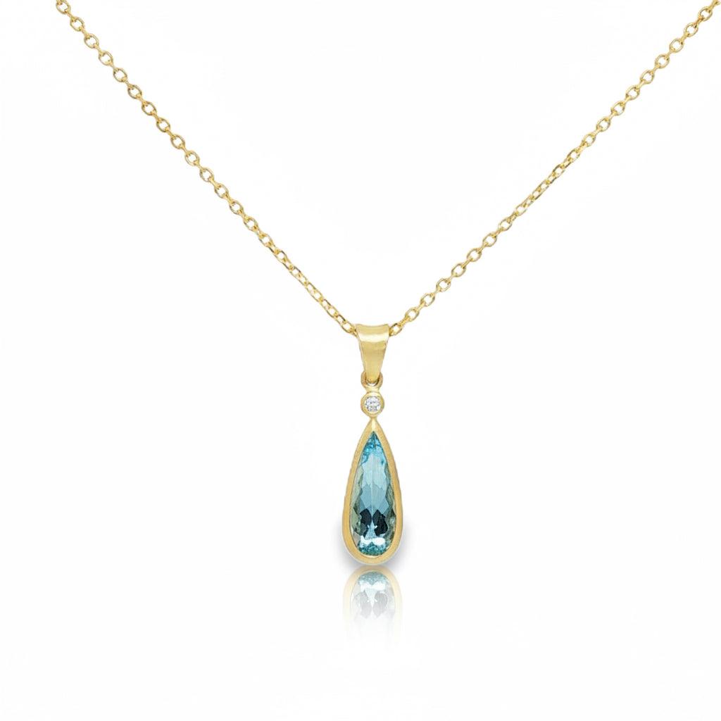 Elongated teardrop aquamarine pendant set in 14K yellow gold bezel setting with satin finish