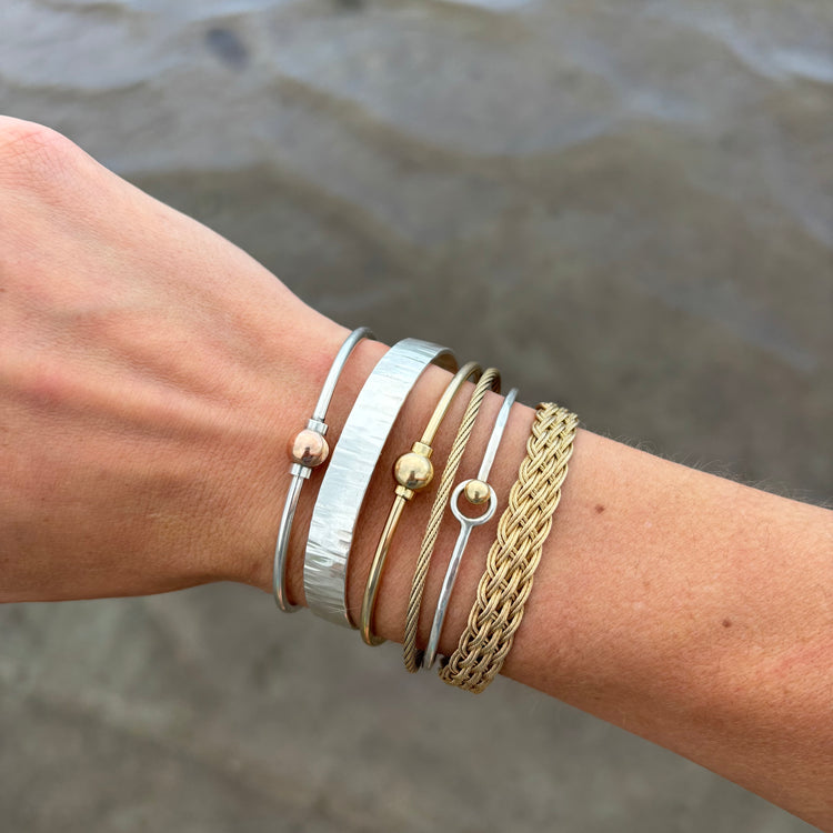 Wrist stack with Cape Cod bracelets, 14K Mariner bracelet, Cape Cod Moontide Bracelet and Ocean Ripple Cuff