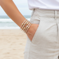 Person wearing cape cod bracelets on a beach