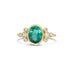 Gold ring with a green tourmaline gemstone and small diamonds on a white background