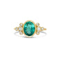 Gold ring with a green tourmaline gemstone and small diamonds on a white background