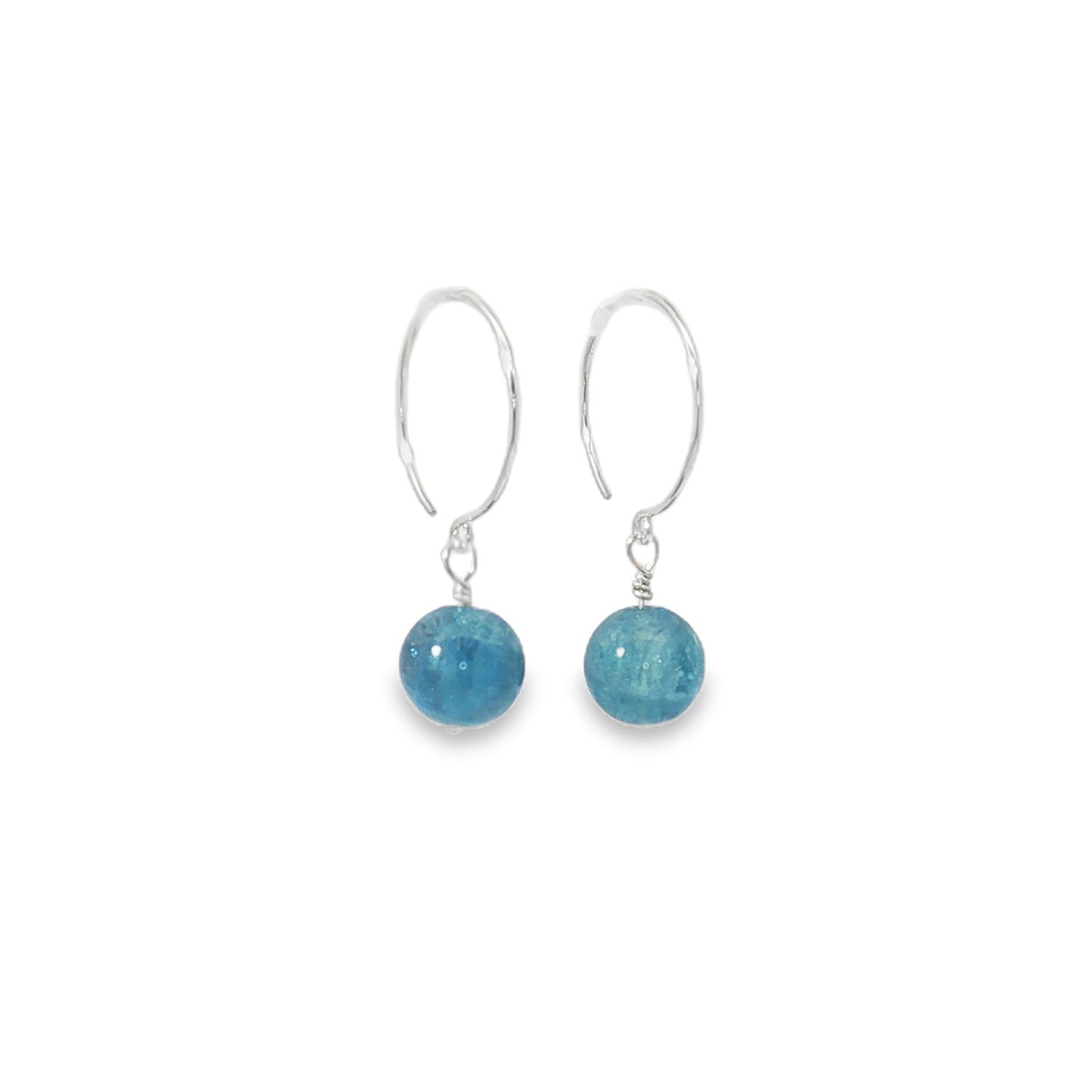 Pair of earrings with blue spherical stones on white background