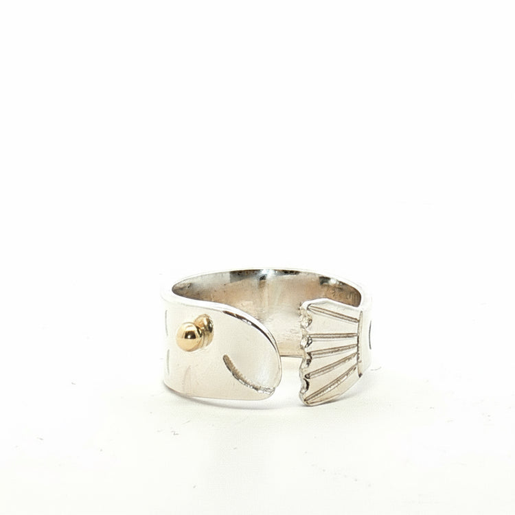 Silver fish ring with gold accent on a white background