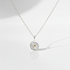Swirling Waters Necklace on flat white surface with cast shadow