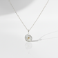 Swirling Waters Necklace on flat white surface with cast shadow